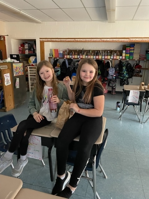 two students enjoy popcorn