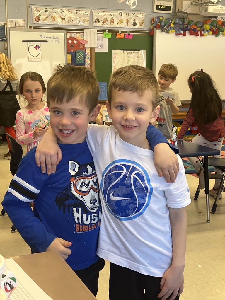 A pair of boys wear white and blue shirts