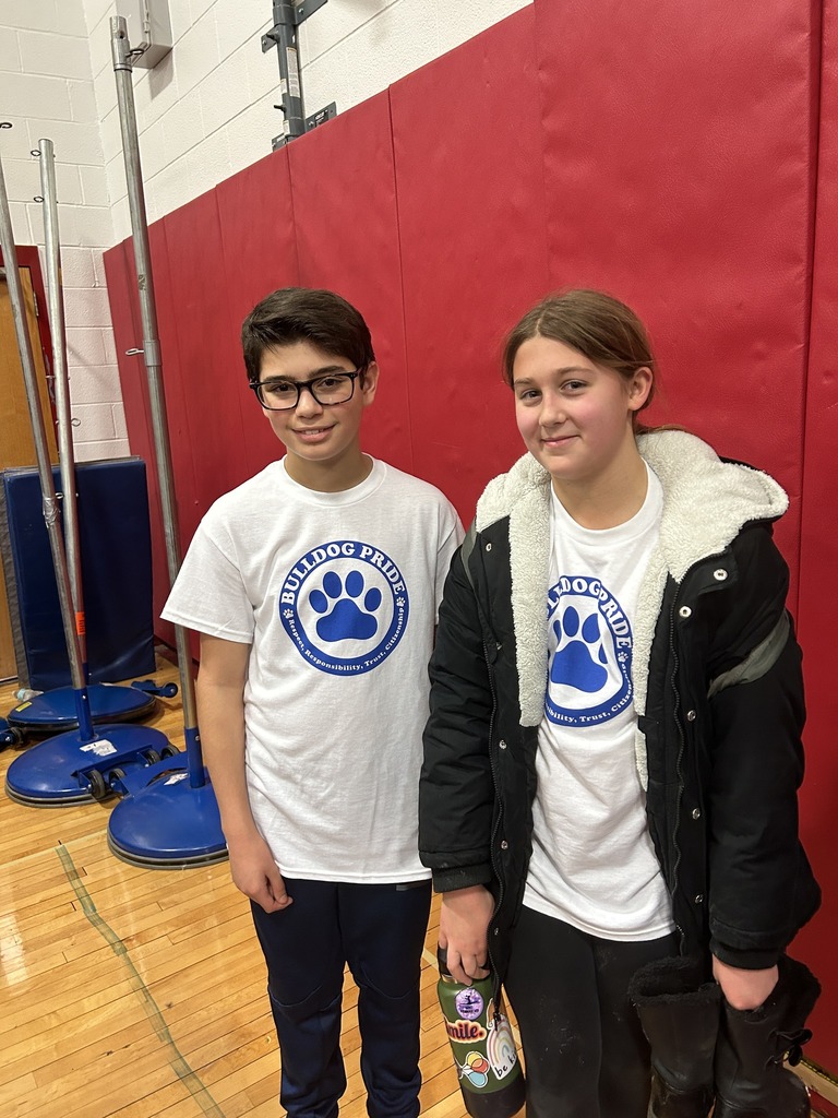 Two students stand in the gym
